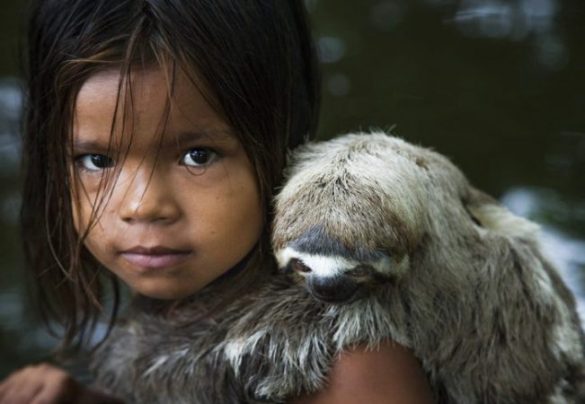 Menina do Rio Negro e seu bicho de estimação. Arredores de Manaus. 2010